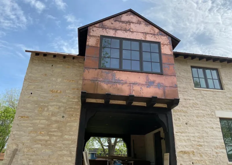 Copper metal panel facade on a stone building for Metal Roof Coating in Felida